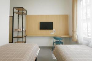 Ένα ή περισσότερα κρεβάτια σε δωμάτιο στο Paskal Inn