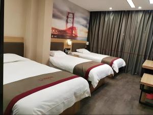 a hotel room with three beds and a painting at Thank Inn Hotel Anhui Fuyang Funan County Yunhe Dong Road in Funan +26 photos