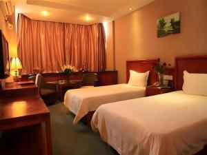 a hotel room with two beds and a window at GreenTree Inn Lanzhou Yantan Road Express Hotel in Lanzhou +92 photos