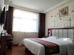 a bedroom with a bed and a window with birds on the wall at GreenTree Inn Yanjiao Haiyou Street Yanchang Road Express Hotel in Gaolou +113 photos