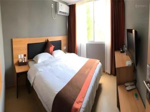 a bedroom with a large bed and a television at Jun Hotel Jiangsu Nanjing Gulou District Gupinggang in Nanjing