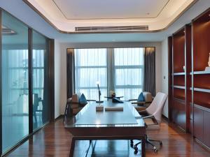 an office with a table and chairs and large windows at ANTHEA HOTEL in Bao'an +188 photos