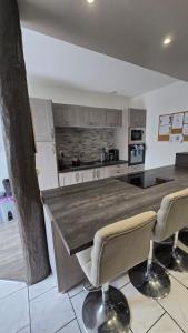 a kitchen with a large wooden table and chairs at Le Goeland in Beauvoir