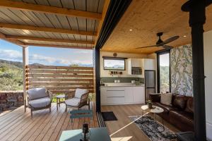 a living room with a couch and a kitchen at Riverbend Farm in Robertson