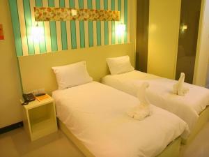 two beds with stuffed animals on them in a room at Ido Boutique Suite in Hat Yai +117 photos