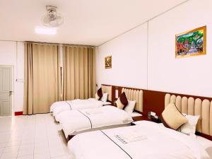 Ένα ή περισσότερα κρεβάτια σε δωμάτιο στο Lan Shang Guesthouse