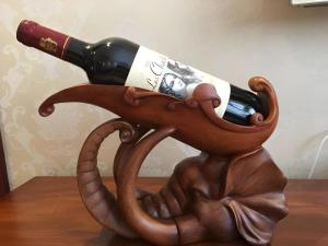 a bottle of wine in an octopus holder at Harbin Baixiang Holiday Hotel in Harbin