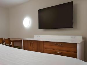 a bedroom with a flat screen tv on a wall at Disney's Pop Century Resort in Orlando