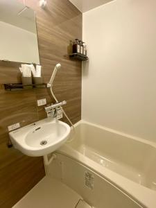 a bathroom with a sink and a bath tub at daren stay in Tokyo