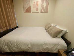 a bedroom with a white bed with a pillow at daren stay in Tokyo +35 photos