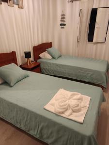 two beds with towels on them in a room at A Casa da Cilarca in Portel