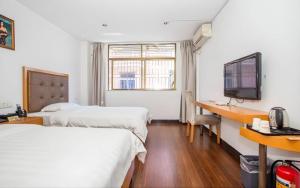 Ένα ή περισσότερα κρεβάτια σε δωμάτιο στο shenzhen kaixin Hotel