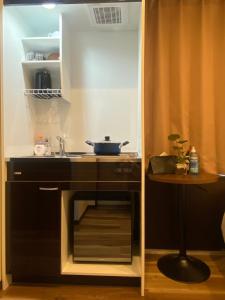 a small kitchen with a sink and a table at daren stay in Tokyo