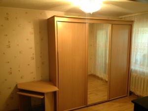 a closet with a wooden door in a room at A comfortable room with balcony in Tallinn