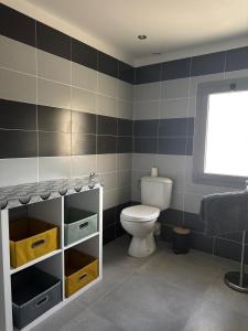 a bathroom with a toilet and a window at Appartement biguglia in Biguglia +7 photos