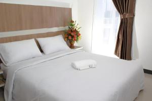 Ένα ή περισσότερα κρεβάτια σε δωμάτιο στο Sakura Manado