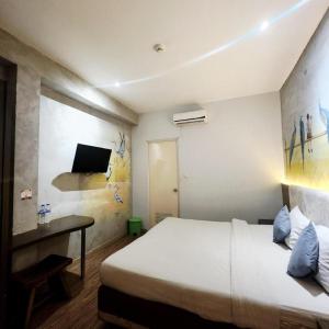 Кровать или кровати в номере Hotel Pantes Semarang