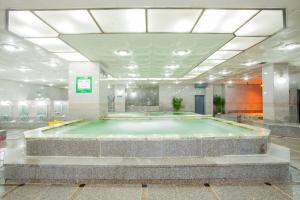 a large swimming pool in a large room with a pool at Ilsung Condo Namhan River in Yeoju