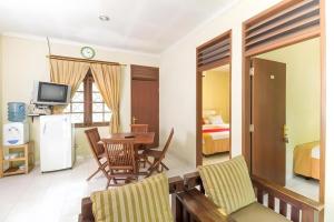a living room with a table and a room with a bedroom at CICO Resort in Bogor