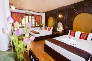 a hotel room with two beds and a bathroom at Aquarius Hotel in Hanoi +134 photos