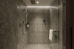 a bathroom with a shower with a glass door at Hyatt Regency Tokyo in Tokyo