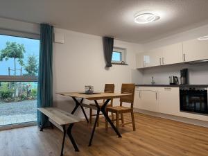 a kitchen and dining room with a table and chairs at Ferienwohnung Seezeit in Bodman-Ludwigshafen