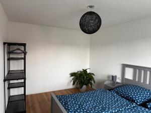 a bedroom with a blue bed and a black ladder at Ferienwohnung Seezeit in Bodman-Ludwigshafen