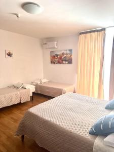 a hotel room with two beds and a window at Hotel Masseria Marziale in Brindisi