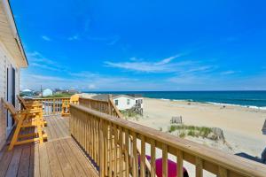 a wooden deck with a view of the beach at 7143 - Geri's Place #4 in Wanchese