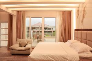 a bedroom with a bed and a chair and a window at منتجع صلالة دريم لاند Salalah Dreamland Resort in Salalah +104 photos