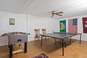 a ping pong table in a living room with an american flag at 6090 - Seas The Day NH in Nags Head