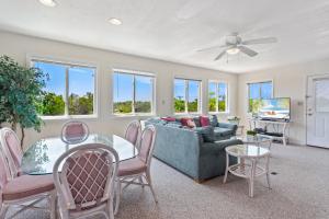 a living room with a couch and a table and chairs at 1702 - Sandpiper Lookout in Poplar Branch