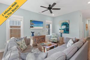 a living room with a couch and a ceiling fan at BCW32A - Sea Escape in Corolla
