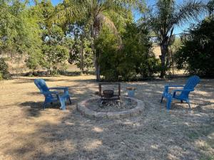 two blue chairs sitting next to a fire pit at 111 Meson Street Gayndah in Gayndah