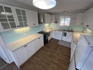 a kitchen with white cabinets and a white counter top at 111 Meson Street Gayndah in Gayndah