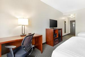 a hotel room with a desk with a bed and a television at Best Western Northwest Corpus Christi Inn & Suites in Calallen