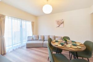 a living room with a table and a couch at AQUA RESIDENCE Sangenjaya in Tokyo