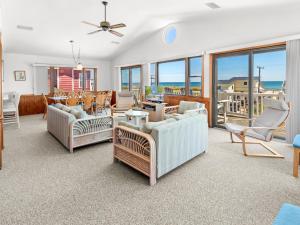 a living room with couches and chairs at 4070 - Sea Spray in Kitty Hawk +58 photos