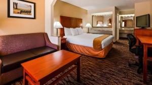 a hotel room with a bed and a couch at Best Western Inn in Clanton +51 photos