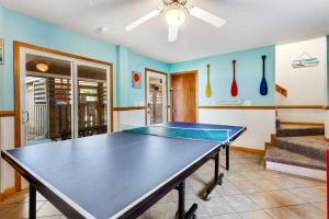 a ping pong table in a living room with a ceiling fan at 2000 - Pipers Paradise in Duck