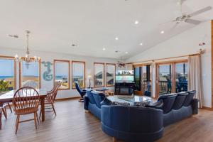 a living room with a blue couch and a table at 7088 - Short II in Grun Island