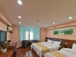 a hotel room with two beds and a television at GreenTree Alliance Jiangsu Yangzhou Hanjiang Middle Road Libao Square Hotel in Yangzhou +67 photos