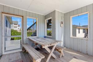 a picnic table on the porch of a house at 7141 - Geri's Place #9 in Wanchese