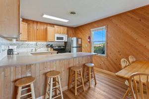 a kitchen with wooden cabinets and a table and chairs at 7141 - Geri's Place #9 in Wanchese +28 photos