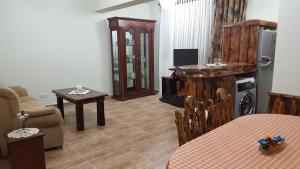 a living room with a couch and a tv and a table at Machanents apartment in Vagharshapat