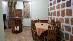 a dining room with a table and wooden chairs at Machanents apartment in Vagharshapat