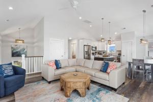 a living room with a couch and a table at 1013 - High Tides and Philly Forever in Corolla +43 photos