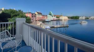 a balcony with a bench and a view of a river at Disney's Boardwalk Inn in Orlando