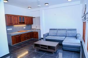 a living room with a couch and a table at Grand Leisure Care & Wellness Resort in Negombo