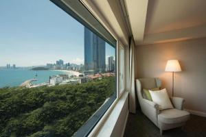 a room with a large window with a view of the city at Hotel Illua in Busan